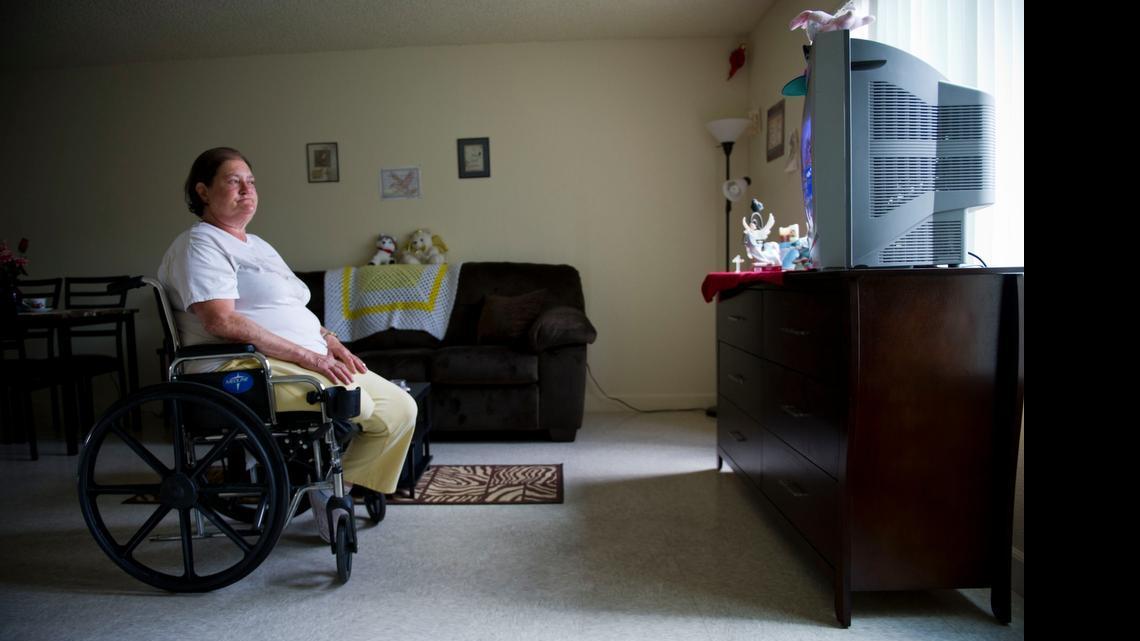 
Cheryl McGuire watches a television show in her new apartment Thursday. McGuire is one of the first residents of Garden Village in south Sacramento – the first apartment complex in the nation to utilize federal funding under a revamped Section 811 Project Rental Assistance Program for low-income, disabled adults.
