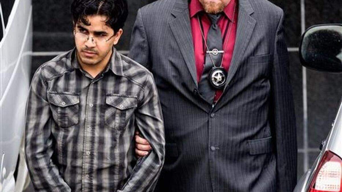 Omar Faraj Saeed Al Hardan, left, is escorted by U.S. Marshals from the Bob Casey Federal Courthouse on Friday, Jan. 8, 2016, in Houston. Al Hardan made his initial appearance in federal court in Houston Friday morning after he was indicted Wednesday on three charges related to accusations he tried to provide material support to the Islamic State group.