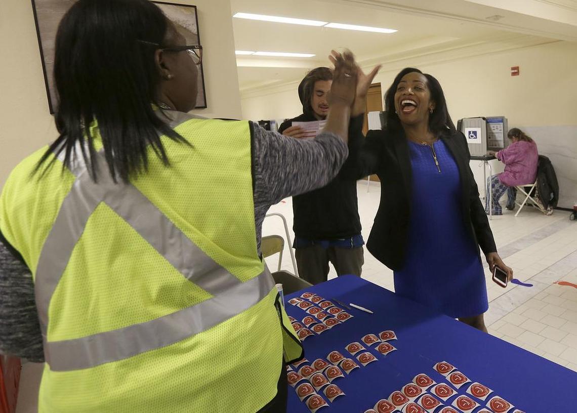 Supervisor Malia Cohen, right, high fives an elections worker after dropping off her ballot at City Hall in San Francisco, Tuesday, June 7, 2016. Voter turnout is expected to be higher then normal in the nation’s most populous state for Tuesday’s presidential primary.