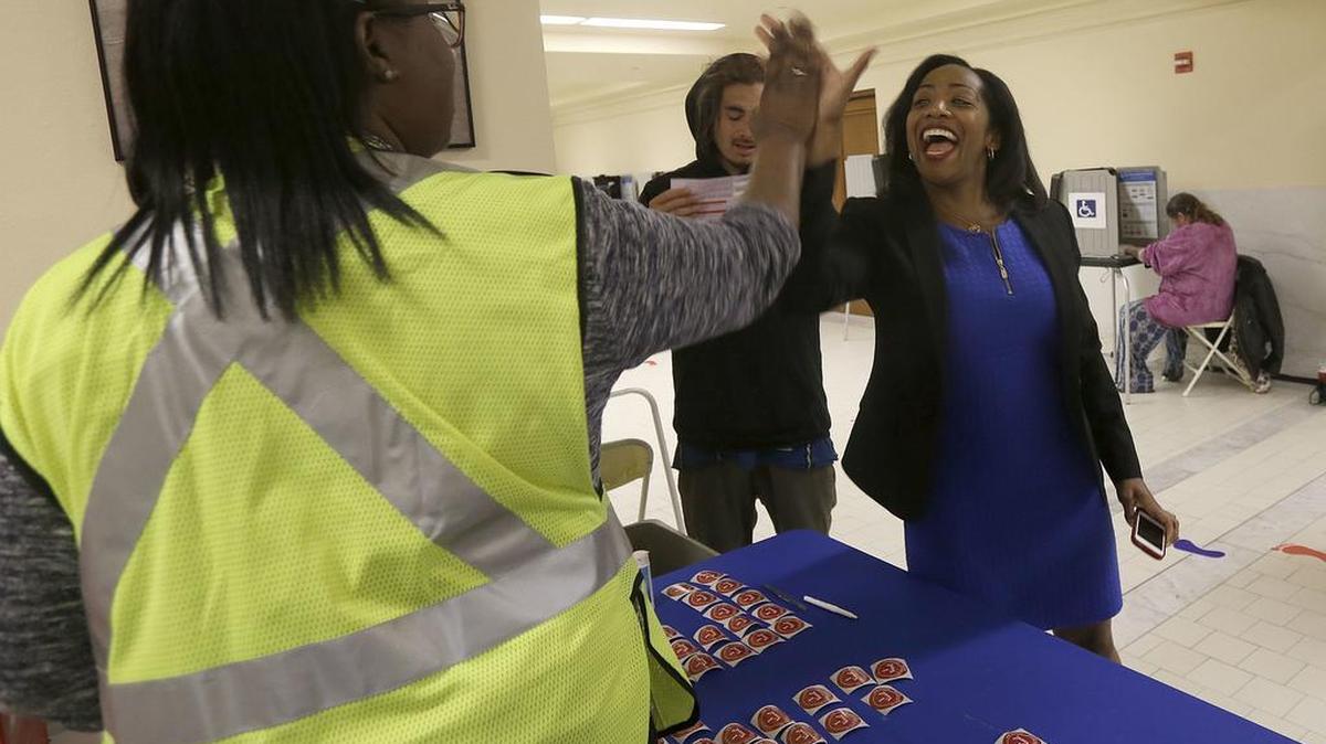 In this June 2016 file photo, Malia Cohen, then a San Francisco supervisor, high-fives an elections worker after dropping off her ballot at City Hall. Cohen is the 2022 Democratic candidate for state controller.