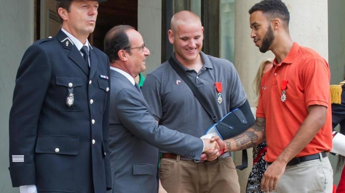 
French President Francois Hollande shakes hands with Anthony Sadler, a senior at Sacramento State University in California, while U.S. Airman Spencer Stone looks on as they leave the Elysee Palace in Paris, France, after Hollande awarded them with the French Legion of Honor on Monday, Aug. 24, 2015. Hollande pinned the Legion of Honor medal on Sadler, Stone, and their years-long friend Alek Skarlatos, who took down a heavily armed man on a passenger train speeding through Belgium on Friday, Aug. 21. 
