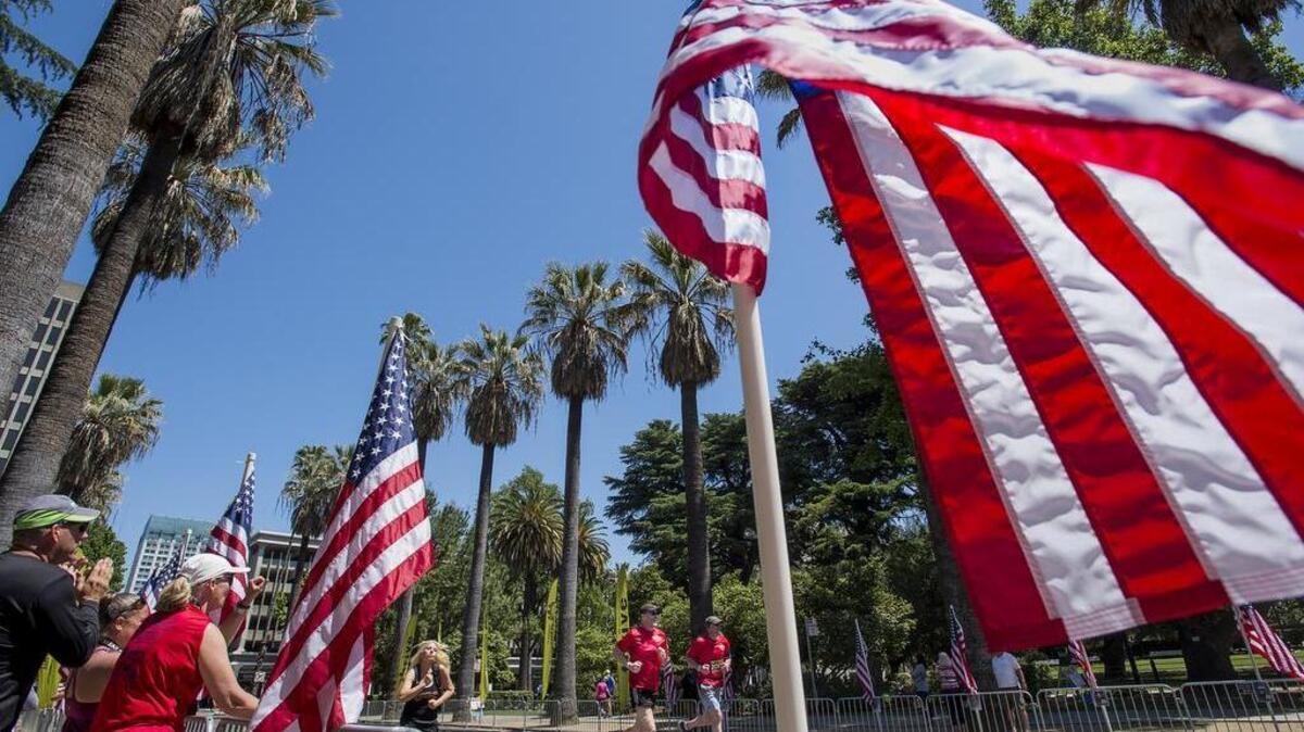 Running team from T. R. Smedberg Middle School in Elk Grove, Alun Wynne, center, and Steve Klein, right, finish the Pony Express marathon at the State Capital on Sunday, May 1, 2016 in Sacramento, Calif.