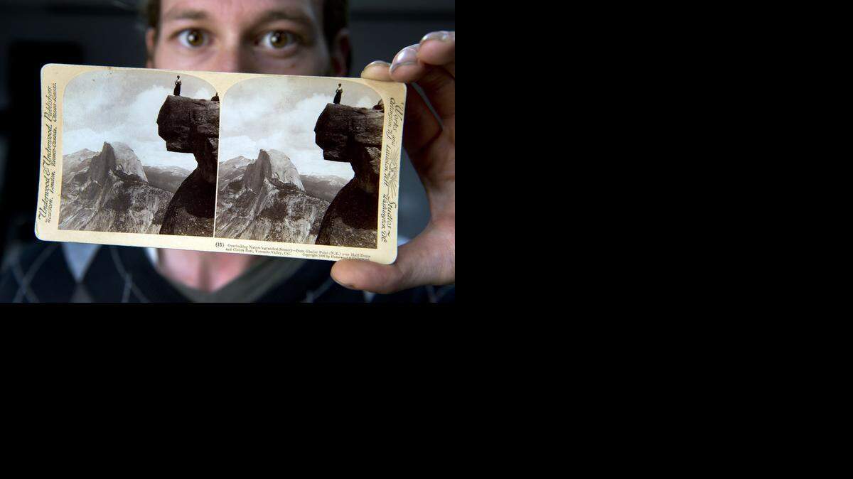 
Matt Bartok holds a stereo card featuring pictures of Half Dome shot from Glacier Point in Yosemite during the late 19th century. State Library 3-D photo experts are in the midst of converting 15,000 old stereo card photographs into digital files. They work largely on giant computer screens where they’re converting the old 19th-century images for viewing by 21st-century audiences.

