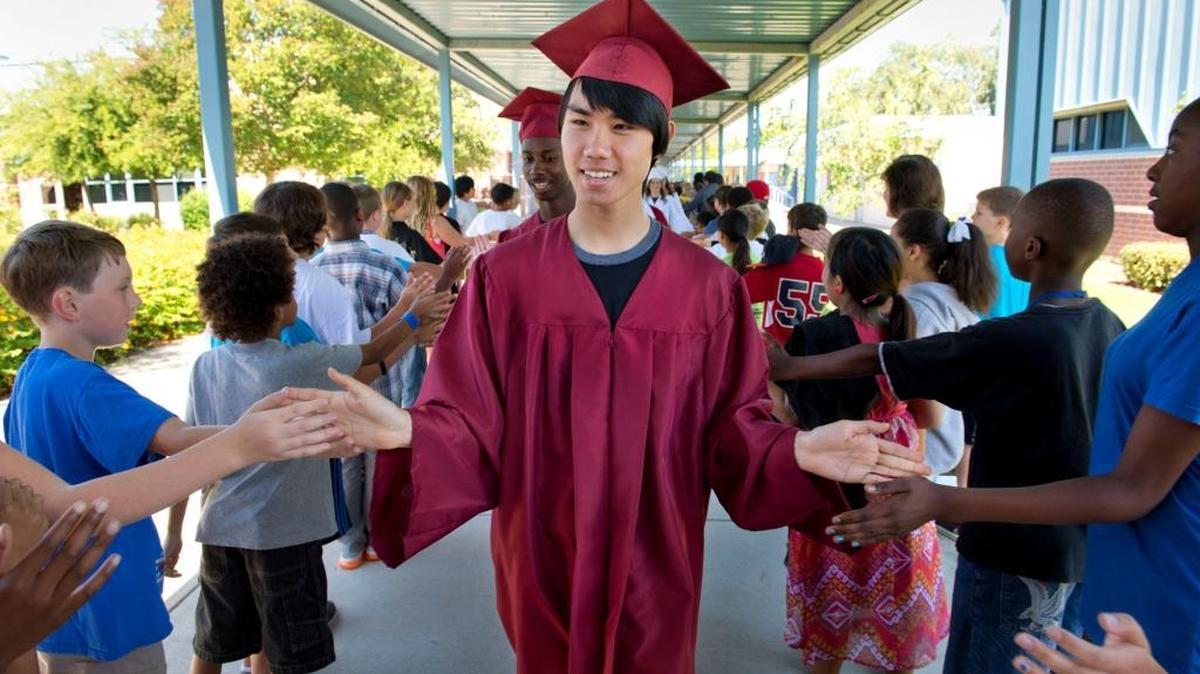 In 2013, Laguna Creek High School senior Lloyd Chen and his classmates are congratulated on their upcoming graduation by students at Foulks Ranch Elementary School in Elk Grove, Calif. Laguna Creek and eight other Elk Grove Unified schools will hold 2017 graduation ceremonies at Golden 1 Center at costs that have yet to be made public. Wednesday, May 29, 2013.