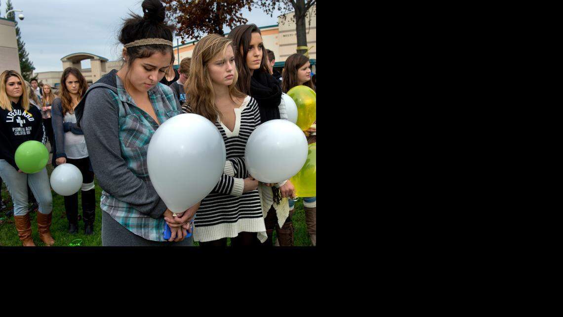 
Folsom High School students sign a pledge to stand up against bullying and are given a yellow ribbon for suicide prevention as they participate in a balloon release for Ronin Shimizu, 12, on Tuesday in Folsom. Ronin, 12, committed suicide Dec. 3. McKenna Quinn, 16, far left, said, “If he was a sad kid he didn’t show it.” She also said the last time she saw him he bought hot chocolate for everyone after rowing practice. Jacquelyn Bass, 17, second from left, said they were in the Upper Natomas Rowing Club with Ronin. Front row from left, Kennedy Marquez, Jaycie Schenone, and Olivia Romano, all 17, attended the balloon release. “We didn’t know him but we were touched by this,” said Romano. 
