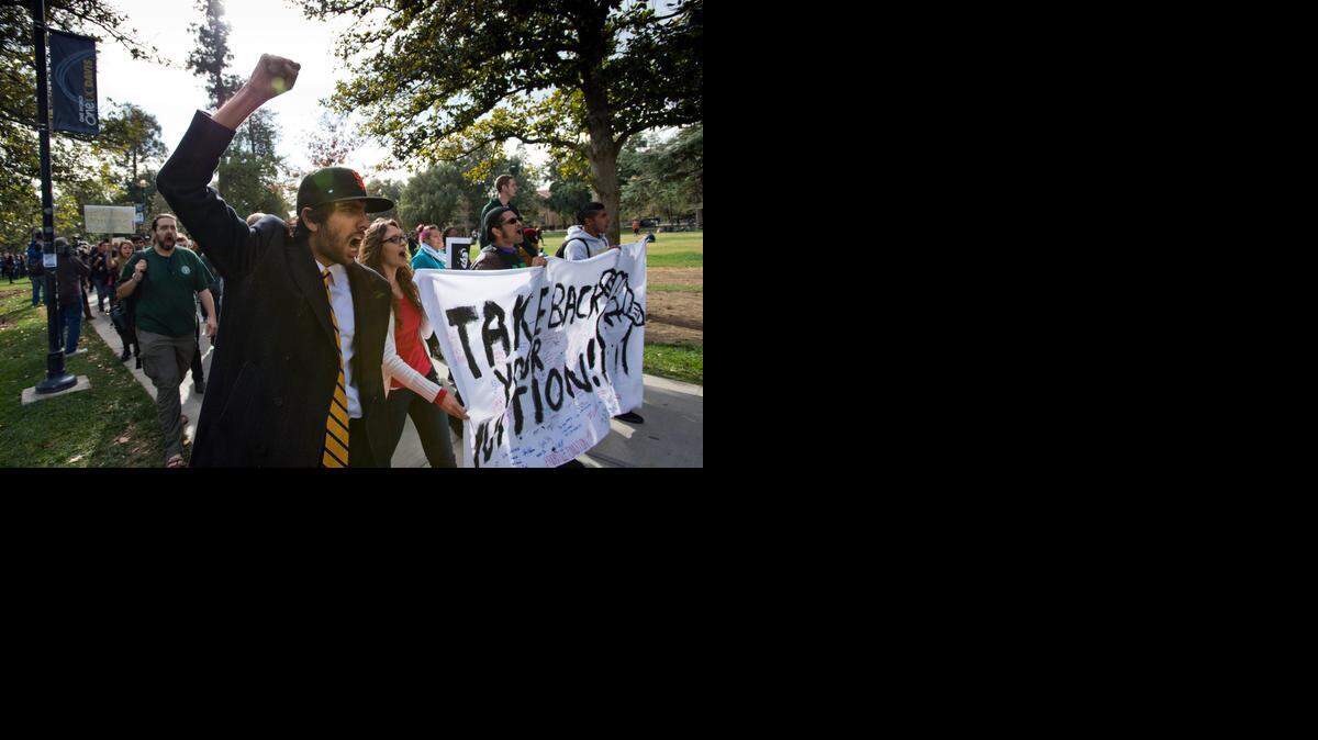 Fifth-year UC Davis student and former student association senator Kabir Kapur leads demonstrators as they march through campus to Mrak Hall on Tuesday protesting a proposal to increase tuition at the University of California system by up to 25 percent over five years.