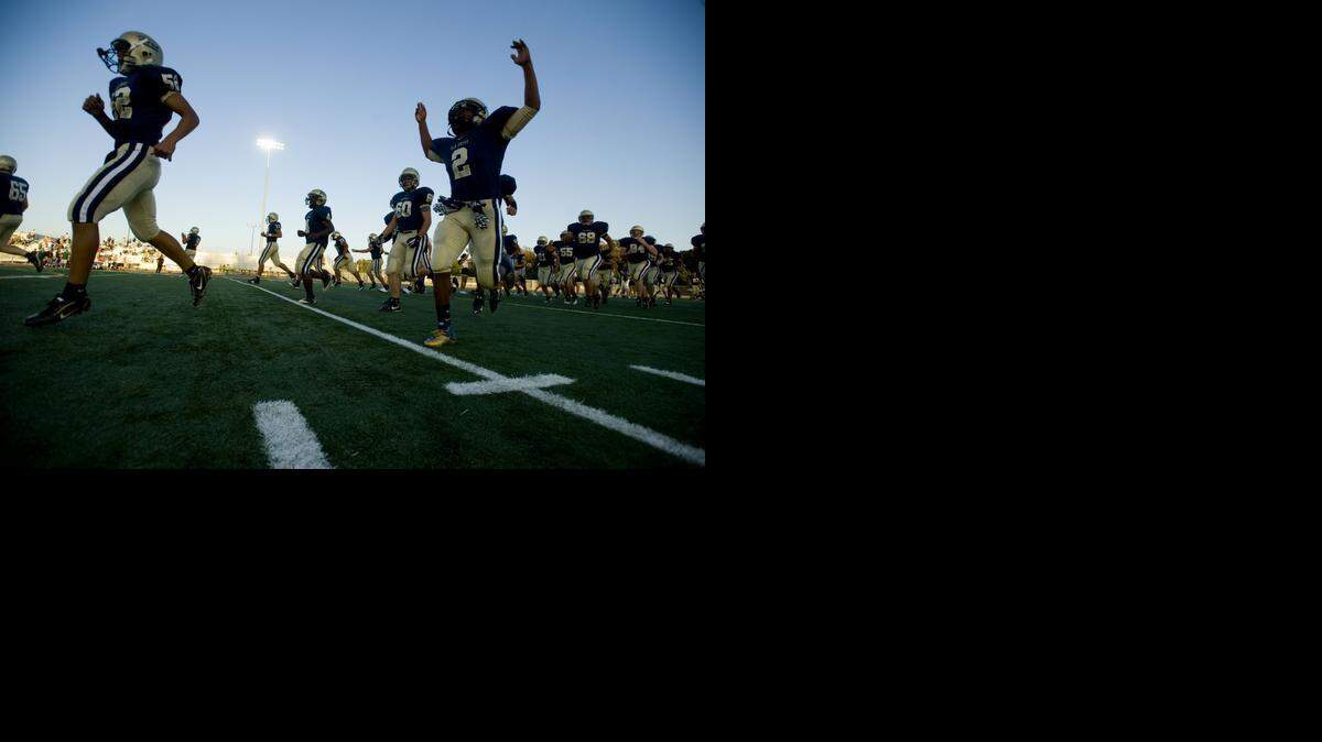 
The football field at Elk Grove High School is covered in synthetic turf, one of several artificial surfaces in the region, which will not be affected by watering restrictions that are expected to turn many playing fields from green to brown as the drought continues.
