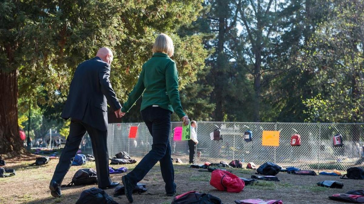 
Sacramento State President Robert Nelsen walks hand-in-hand with his wife, Jody Nelsen, on Monday, Oct. 5, 2015, through an exhibit of 1,100 backpacks on campus called “Send Silence Packing.” The national traveling exhibit illustrates a heartbreaking statistic: More than 1,100 college students die by suicide each year. Many of the backpacks tell the story of a young person lost to suicide.
