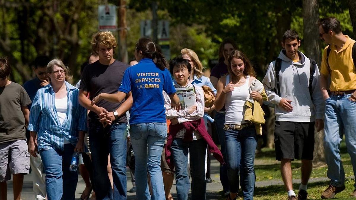 FILE - Walking backward, tour guide Brie-Anna Rojas, center with back to camera, leads potential incoming freshmen and others during a walking tour of the campus at UC Davis in Davis on Monday, April 14, 2008. The University of California announced Monday that freshman acceptances rose notably throughout the system this year.