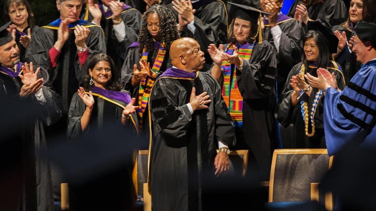 Rep. John Lewis, center, receives applause after delivering the keynote address for UC Davis School of Law graduates at the Mondavi Center on Saturday, May 14, 2016. Lewis said lawyers were invaluable to the civil rights movement and that much more needs to be done to advance the causes of justice.
