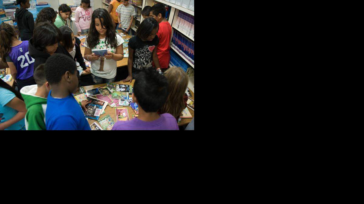 
Daisha Correa, center, and other students pick out a free book in the library at Bannon Creek Elementary School in Natomas in 2010. Natomas Unified School District leaders may add portable classrooms and shift sixth-graders to middle school to reduce potential overcrowding.
