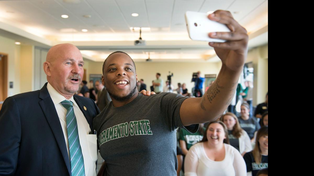 
CSUS President Robert Nelsen stands next to graduate student Damariye Smith, 24, who takes a selfie before Nelsen is formally introduced during a news conference at Sacramento State on Wednesday.
