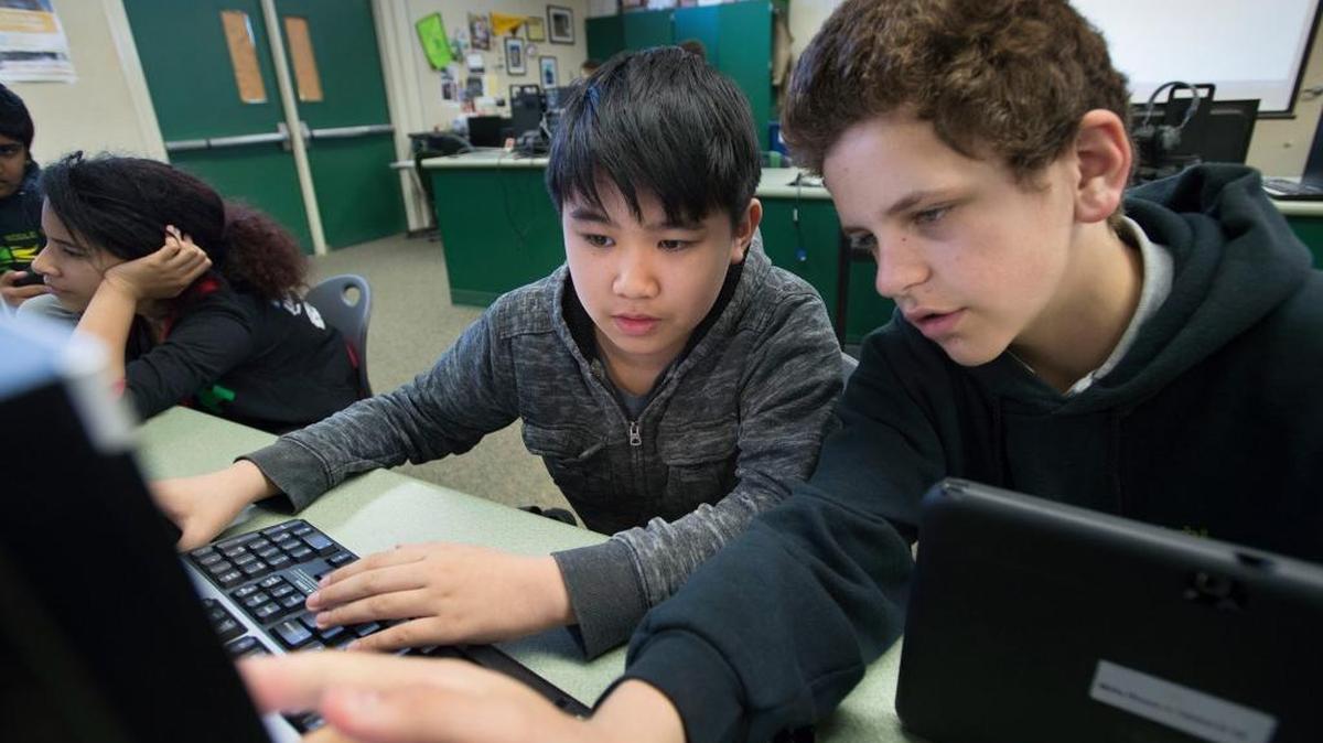 Seventh-graders Jason Tran, left, and David Sushkov work out a problem with a kid-friendly coding program in their computer science class at Mills Middle School in Folsom Cordova Unified School District. Dedicated computer programming classes remain a rarity in California schools, even as the information technology sector is exploding.