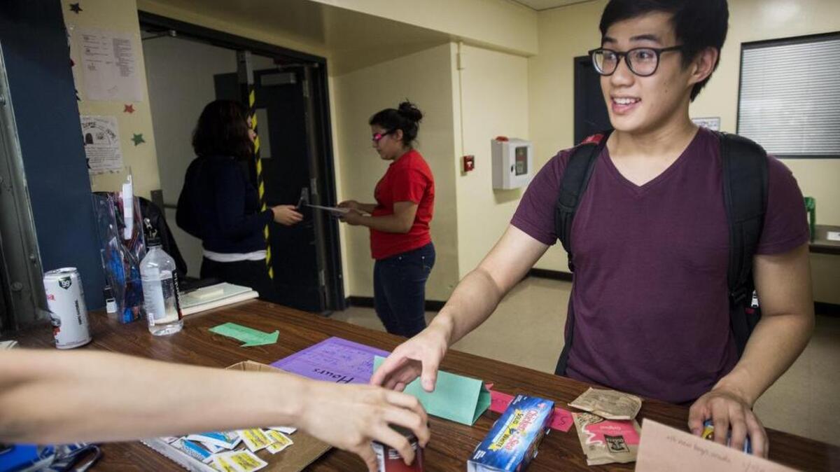 Ivan Shan, a senior at UC Davis, receives several items of food from The Pantry on Monday, July 28, 2016.