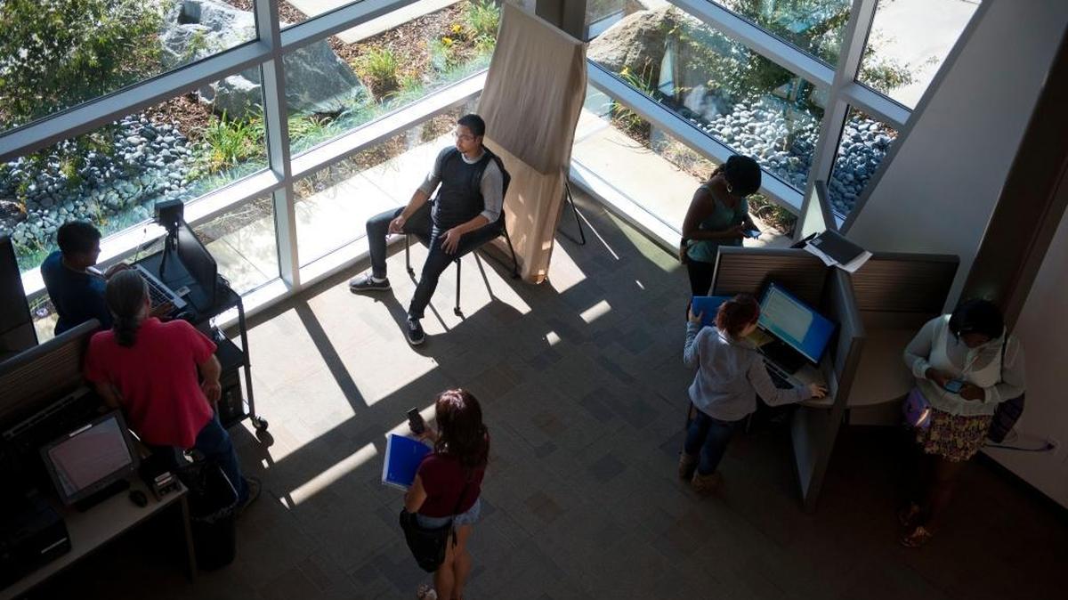 Eduardo Ramos, center, has his photo ID picture taken on the first day of school at the Los Rios Community College District expansion in Elk Grove on Monday, August 26, 2013.