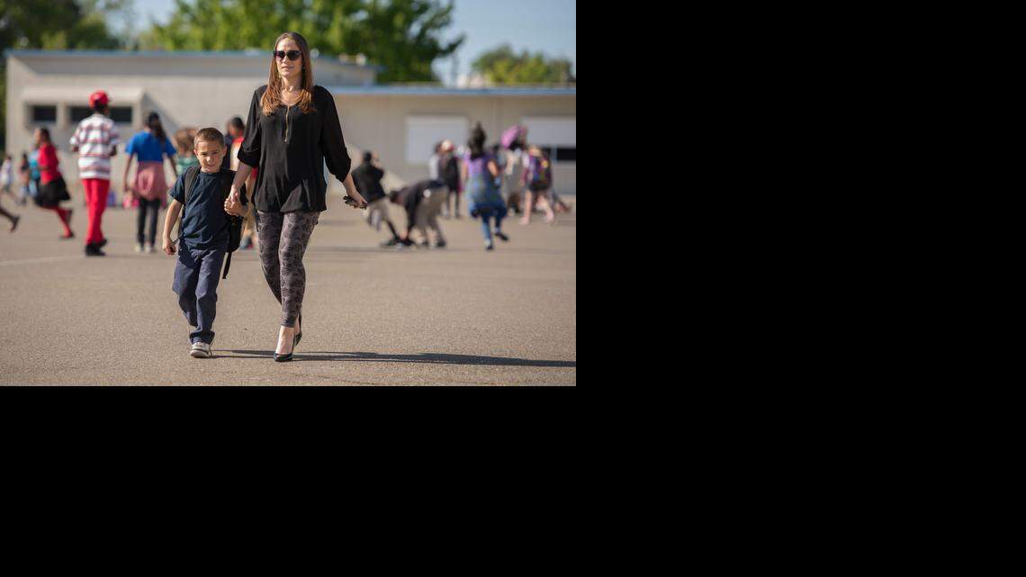 
Amber Pena picks up her son Marco, 6, at the afternoon START program run by the city at Tahoe Elementary School in Tahoe Park.
