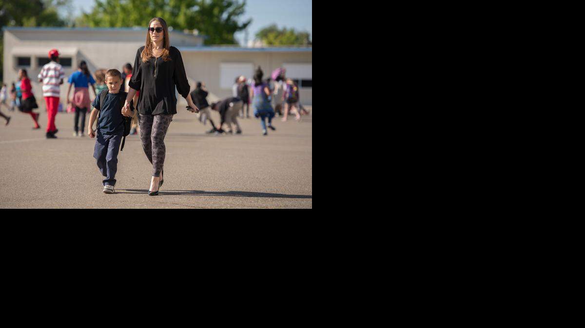 
Amber Pena picks up her son Marco, 6, at the afternoon START program run by the city at Tahoe Elementary School in Tahoe Park.
