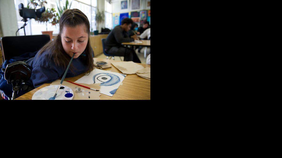 
Stephanie Arnold, 15, uses her mouth to hold a paintbrush in art class at Luther Burbank High School in February. Stephanie has arthrogyposis, a rare condition that limits the use of her arms and legs. But she doesn’t let it hold her back in school.
