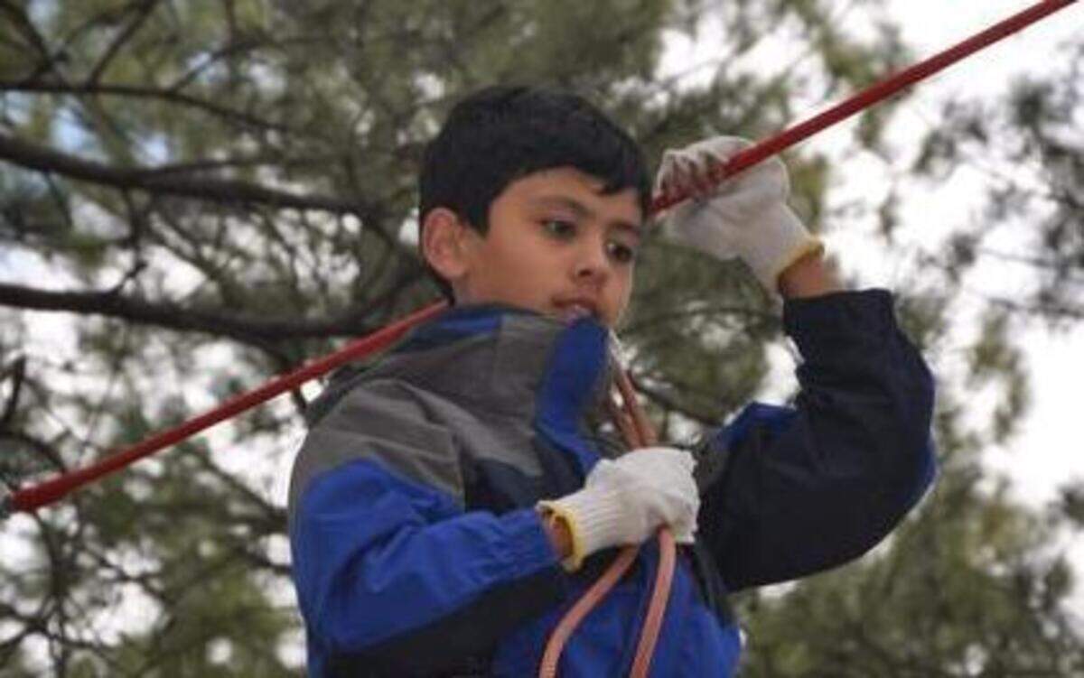 
Aidan Fong practices climbing using ropes at an adventure course last year in Flagstaff, Ariz.
