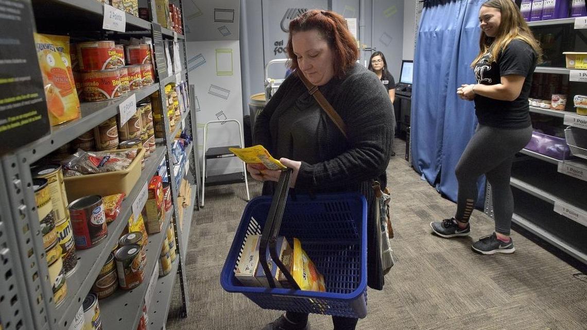 Graphic design major Elizabeth McGuire shops for a few grocery items at the campus food pantry at Sacramento State on Thursday, Nov. 30, 2017. McGuire is one of the estimated 3,600 homeless students at Sacramento State.