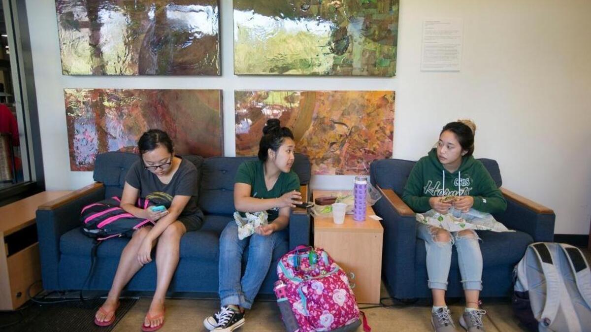 
Sophomore students Lor Vang, left, Angel Xiong and Jessica Vang eat lunch outside the Full Circle Project office on the Sacramento State campus on Monday.
