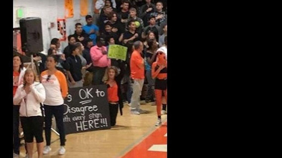 A Facebook post by a Woodland High School parent shows teacher Windy Pappas kneeling during the national anthem at a homecoming rally on Friday. The post by Amy Plunkett was supportive of Pappas and generated more than 500 reactions.