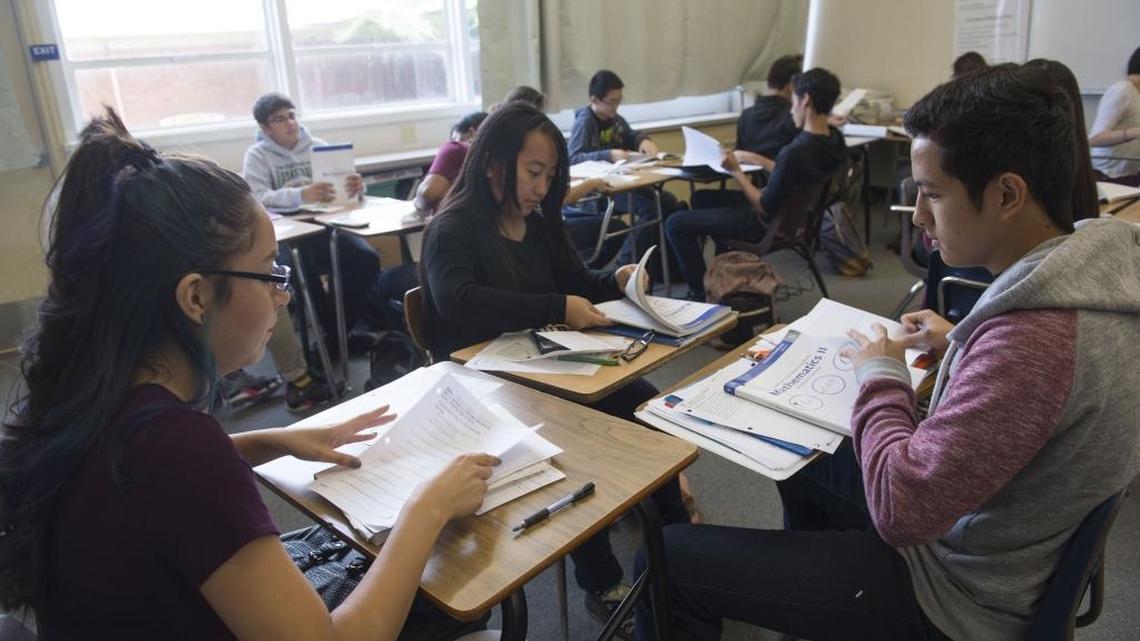 Karen Villegas, 15, left, Christy Xiong, 15, and Michael Ly, 15, right, study together in a math class, Thursday, Oct. 8, 2015, at West Campus High School, which has been ranked among the best public high schools in the state and nation.