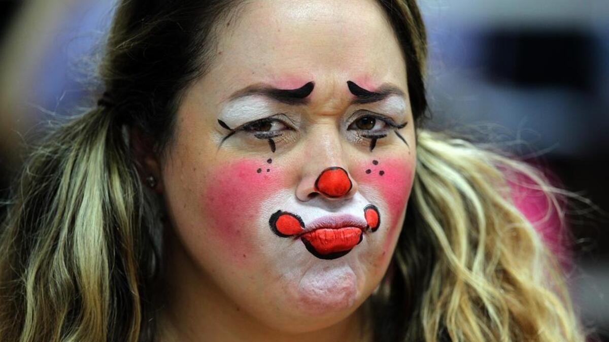 Vanessa Concepcion reacts with sadness after getting her face painted as a clown at the office of Silly Farm Supplies in Davie, Fla. She feels that clowning is a proud profession that has been hurt badly by these creepy clown episodes, on Tuesday October 18, 2016.