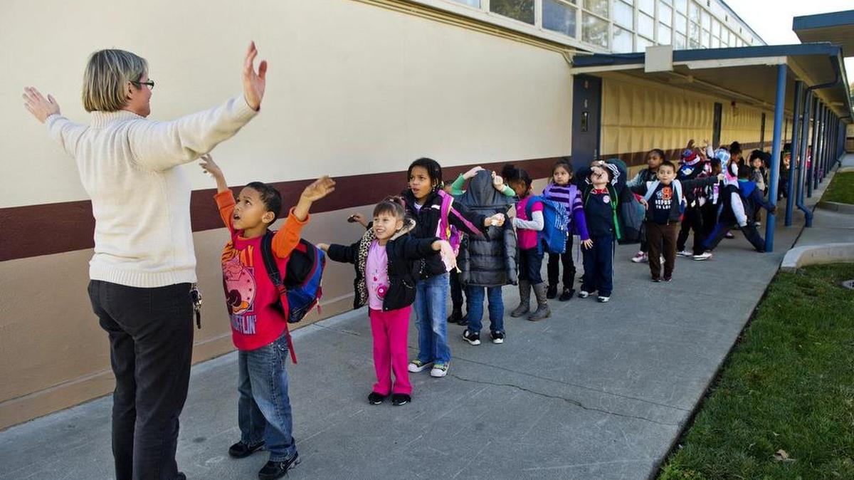 Katherine Hoffmore, 48, occupies her students in line at Greer Elementary as they get ready to go home for the day. Expected to cost about $7.5 million a year for salaries and benefits, the decision to lower class sizes brings the district in line with a new state formula that gives districts more money if they reduce their class sizes by the year 2020. Sacramento City Unified plans to add 75 teachers at 47 schools.