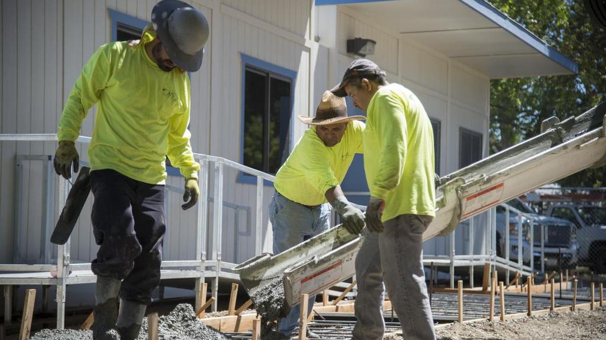 Workers with AJ’s Concrete and Landscape Contractors pour a sidewalk in front of a new portable classroom on July 11 at Ethel Baker Elementary. Nine Sacramento elementary schools are getting about 20 portables for the fall semester to handle the added classes required for class-size reductions.