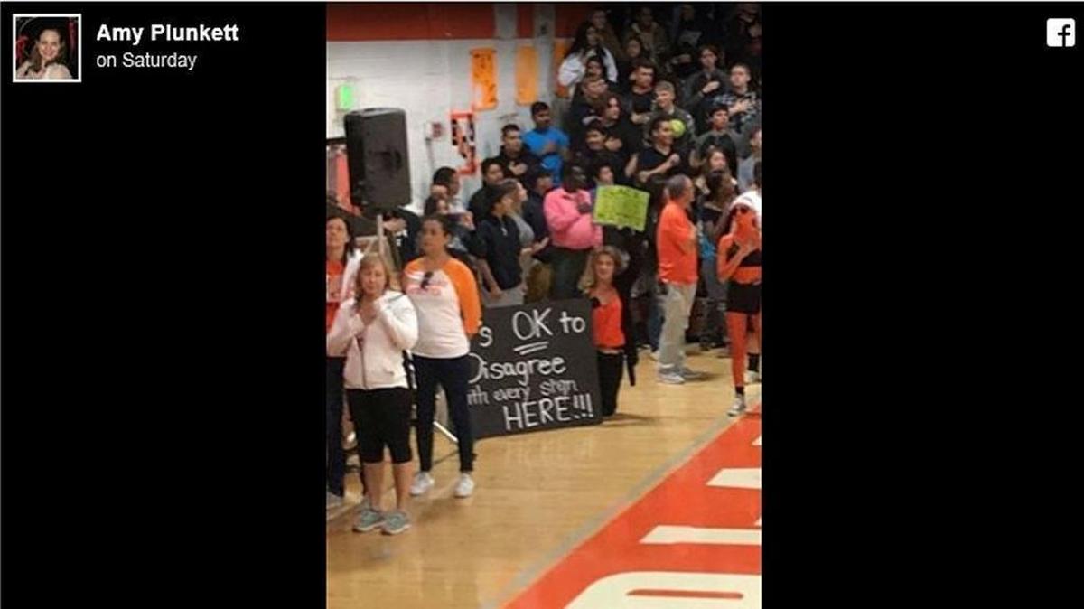 A Facebook post by a Woodland High School parent shows teacher Windy Pappas kneeling during the national anthem at a homecoming rally on Friday. The post by Amy Plunkett was supportive of Pappas and generated more than 500 reactions.