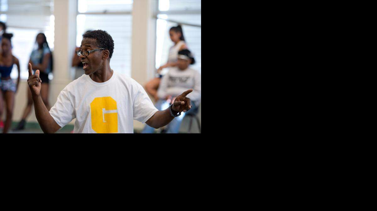 
Grant High School teacher James Van Buren – know affectionately as “Mr. V” by students – leads drum-line practice in September at Grant High School. 
