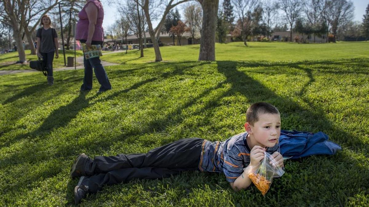 Nikolai Lasswell, 7, of Woodland eats a snack as he and his grandmother, Helen Pomerleau, wait for his sister, Makayla Lasswell, 11, left, after school at Willett Elementary in Davis on Tuesday. The Lasswells are one of hundreds of families who drive to the Davis Joint Unified School District every school day. A falling birthrate in Davis has opened the door to an increasing number of inter-district transfers.