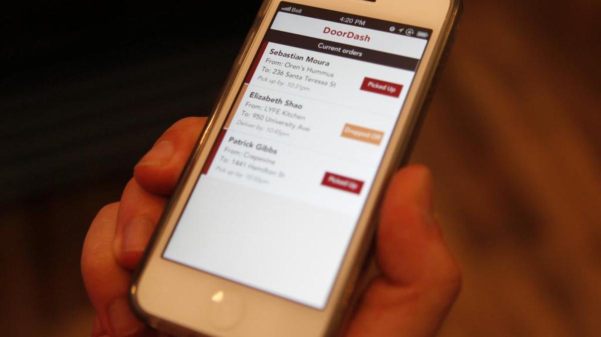 DoorDash driver Jake Vertin shows his orders in 2013 in Palo Alto, Calif. Granite Bay High School has banned its students from using the app to deliver food during the school day.