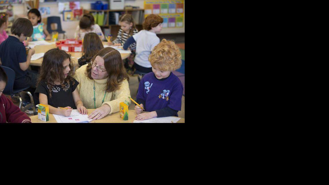 
Kindergarten teacher Peggy Watson, center, helps students Jordyn Mejias, left, and Andrew Henrikson in her class at Phoebe Hearst Elementary School in Sacramento on Friday, January 31, 2014.
