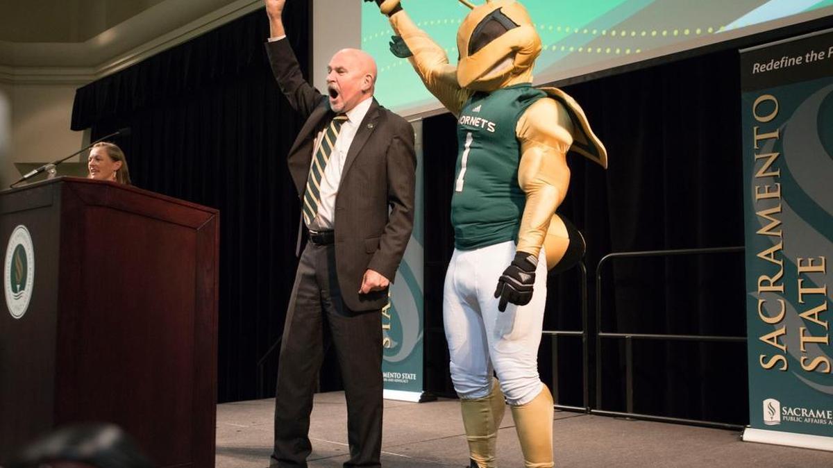
Sacramento State President Robert Nelsen, with the Hornets mascot by his side, chants, “Sac State is No. 1. Stingers up!” following his first annual address to students and facultyThursday.

