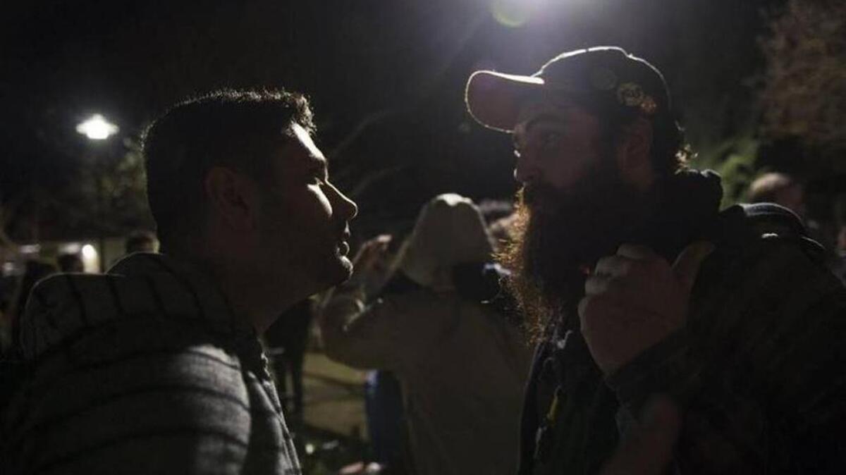 UC Davis grad student Arash Razavi, who came to see Milo Yiannopooulos speak, is confronted by protesters who came to condemn the guest speakers outside of the Sciences Lecture Hall at UC Davis on Friday, Jan. 13, 2017, in Davis, Calif.