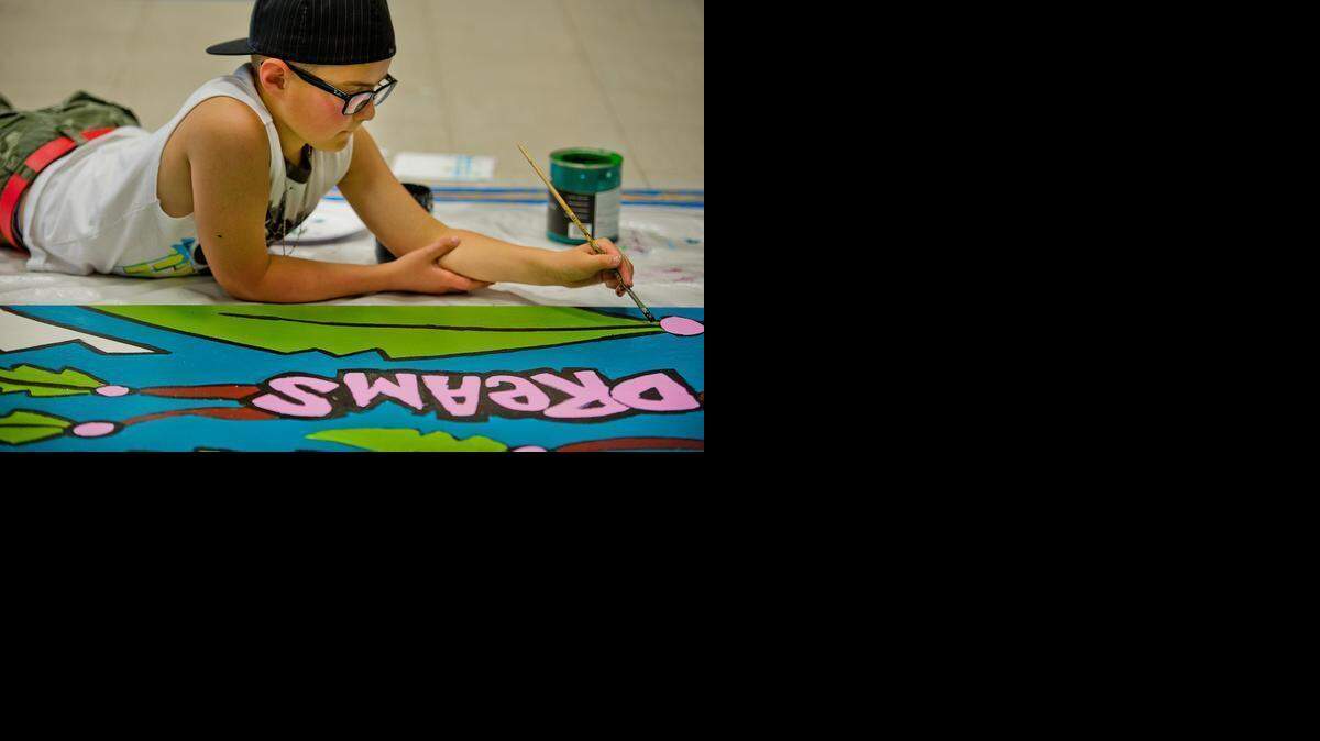 
Washington Elementary School student Zackery Turkins concentrates on painting a mural in 2013 just before the campus closed. Half of the mural went to WIlliam Land Elementary and the other half went to Theodore Judah Elementary, the two schools to which Washington students were reassigned. Two local leaders are proposing to reopen the campus.
