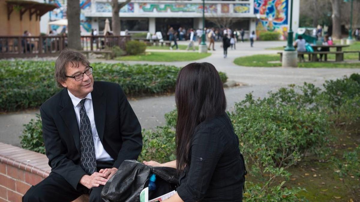 Jim Draga chats with Zoey Pha, a junior psychology major at Sacramento State, on Thursday, Feb. 11, 2016. Draga, called the “graduation czar,” was hired to help the college improve its four-year graduation rate.