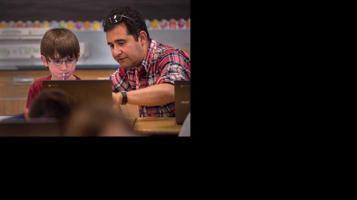 
Fifth-grade teacher Pedro Perez, right, helps Thomas Babcock, 10, during a practice math test March 26 at Folsom Hills Elementary School.
