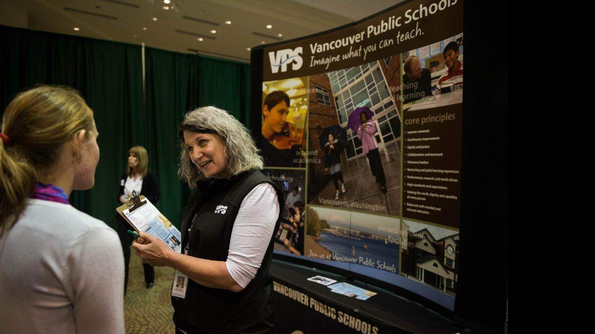 
Vancouver Public Schools representative Vicky Barnes talks to a teaching candidate last week at a recruitment expo at Sacramento State. Barnes said the Washington school district is looking to hire 200 teachers.

