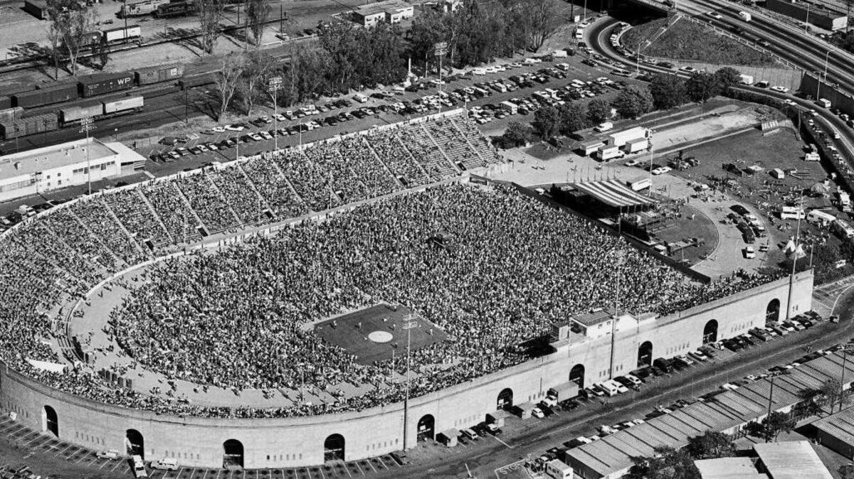 Sacramento Bee Photo - Published May 2, 1976. More than 24,000 people jammed into Hughes Stadium on the Sacramento City College Campus yesterday, filling the stands and covering the athletic field to hear performers including Linda Ronstadt, The Eagles, Jimmy Buffett and others. The square, open patch in the crowd is the baseball infield and pitcher’s mound used by the Sacramento Solons AAA team for their home games of the Pacific Coast League 1974-1976. It was fenced off to protect its surface during the all-day concert.
