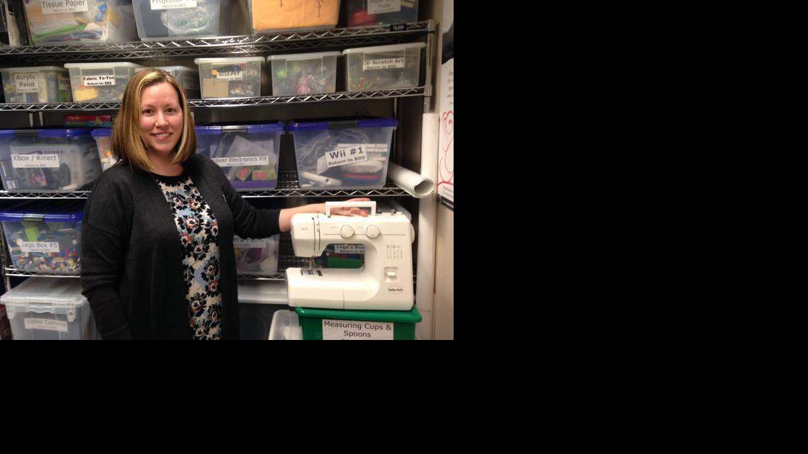 
Sacramento Public Library employee Lori Easterwood shows one of six new sewing machines that will be available for loan through a new “Library of Things” program. 
