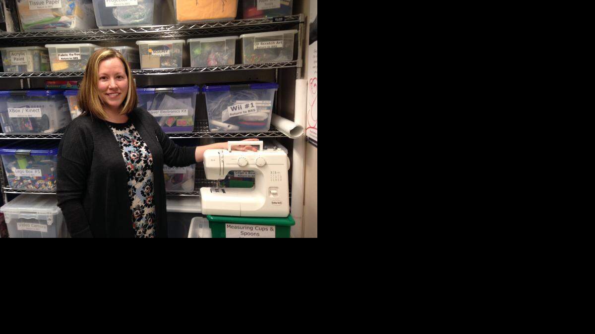 
Sacramento Public Library employee Lori Easterwood shows one of six new sewing machines that will be available for loan through a new “Library of Things” program. 
