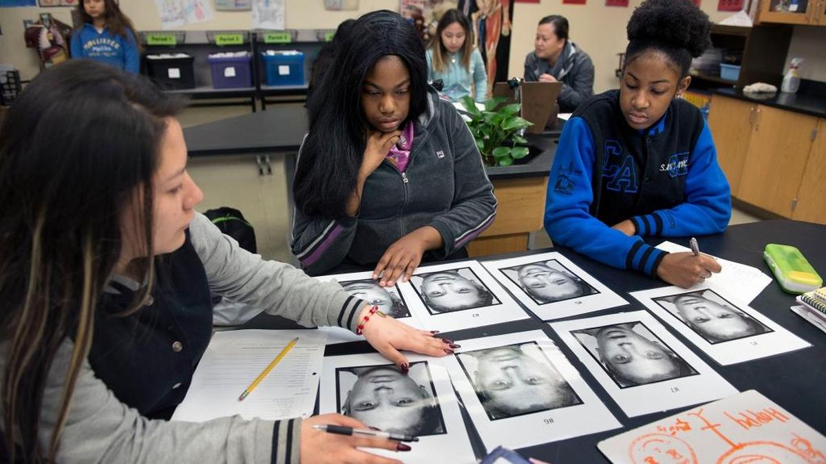 Ninth-graders, from left, Araceli Romero, Natasha Moody and Alexis Tarleton match a written list of emotions with the appropriate facial expressions during class at Health Professions High School last month in Sacramento.