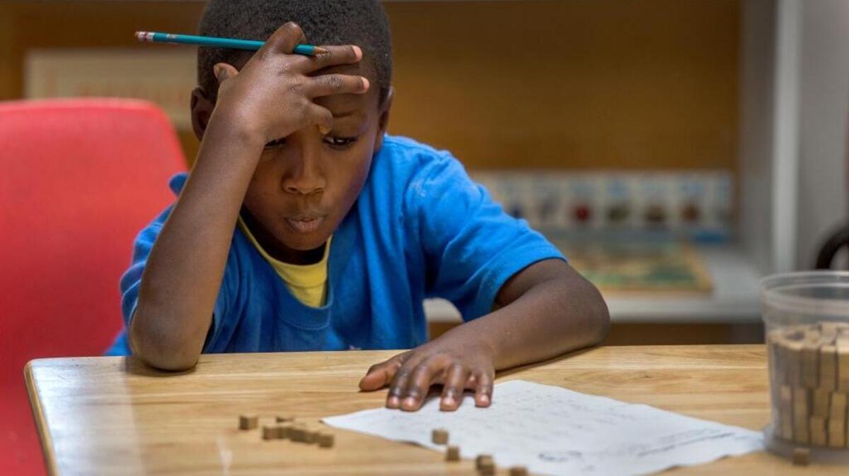 
Isaiah Brumfield, 6, works on a math lesson at Mustard Seed School on Oct. 1 in Sacramento. He is the youngest of three siblings attending the school. 
