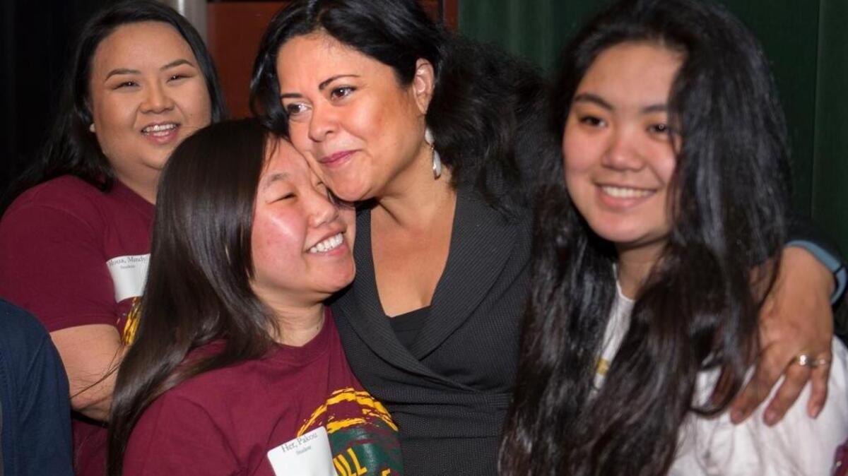 Maya Soetoro-Ng, center, the half-sister of President Barack Obama, hugs Pakou Her, second from left, and other members of the Full Circle Project before speaking to students about leadership and conflict resolution at Sacramento State on Friday, Feb. 26, 2016 in Sacramento, Calif.