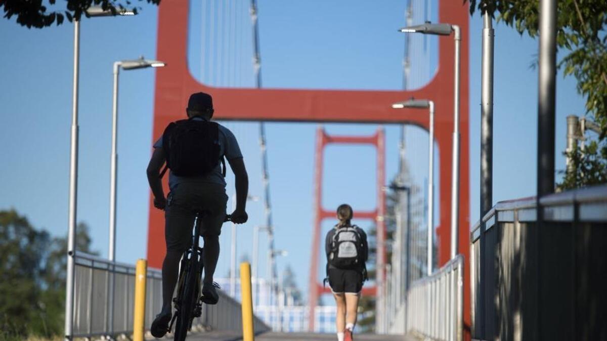 FILE -- A bike rider heads over the Guy West Bridge toward Sac State on Monday, April 25, 2016 in Sacramento, Calif.