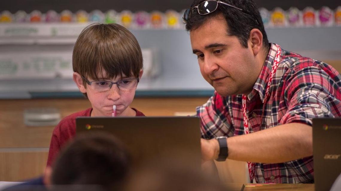 Fifth-grade teacher Pedro Perez, right, helps Thomas Babcock, 10, during a practice math test on March 26, 2015 at Folsom Hills Elementary School. The state Board of Education will decide Thursday how to evaluate schools based on test scores and several other factors.