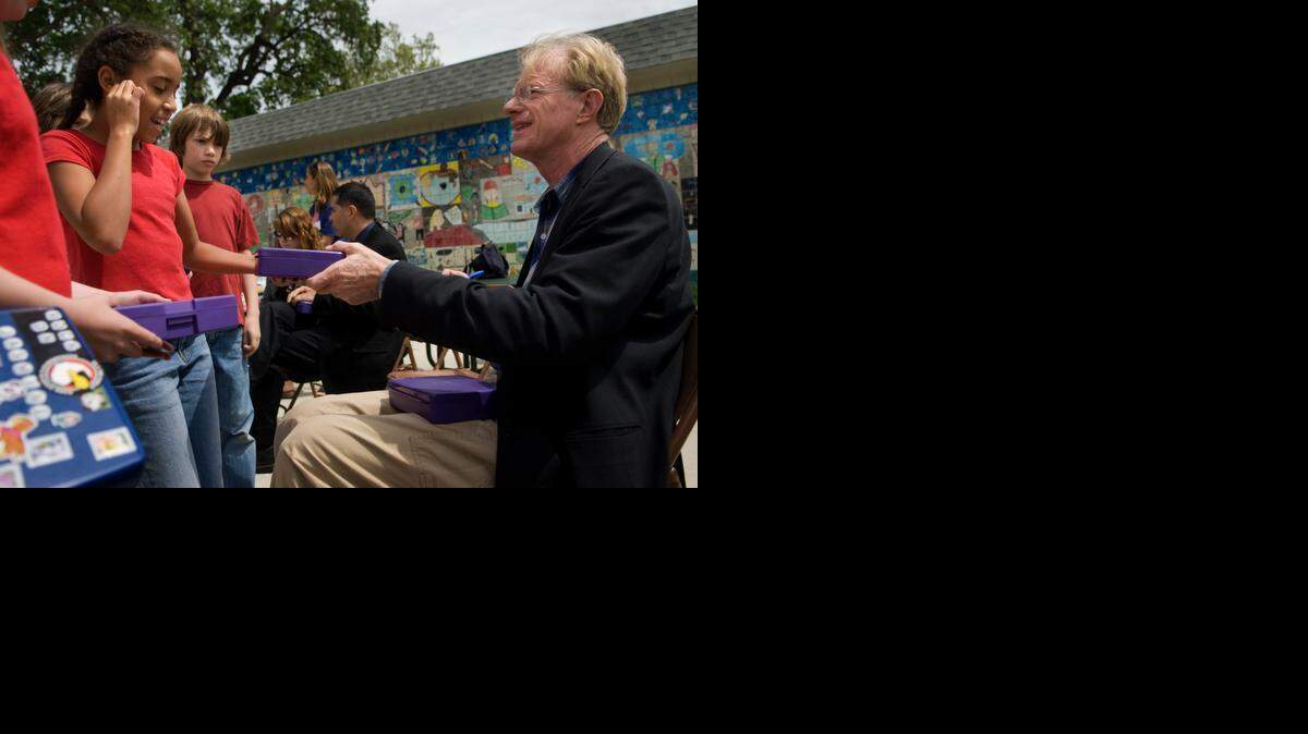
Actor and environmentalist Ed Begley Jr. right, signs a lunch box for Zoe Reese, 10, at Crocker/Riverside Elementary School during an event to celebrate Earth Day in 2008. The school in an affluent city neighborhood is seeing tension between two parent fundraising groups this year.
